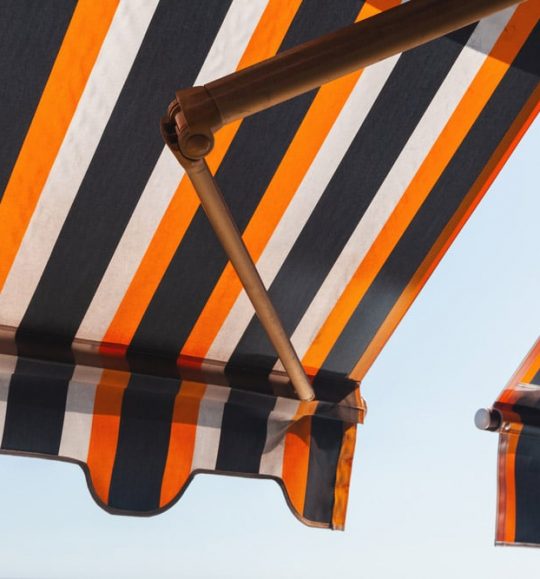 Orange And Black Stripped Awning — Door & Window Furnishings in the Northern Rivers
