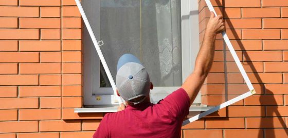Man Installing Window Flyscreen — Door & Window Furnishings in the Northern Rivers