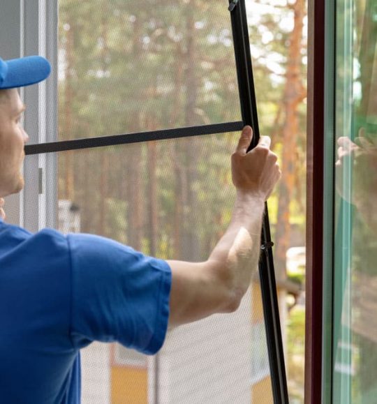 Worker installing window — Door & Window Furnishings in the Northern Rivers