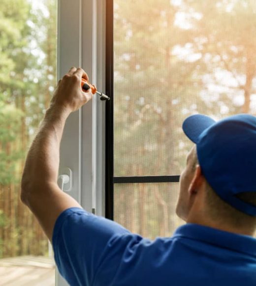 Worker screwing the window — Door & Window Furnishings in the Northern Rivers